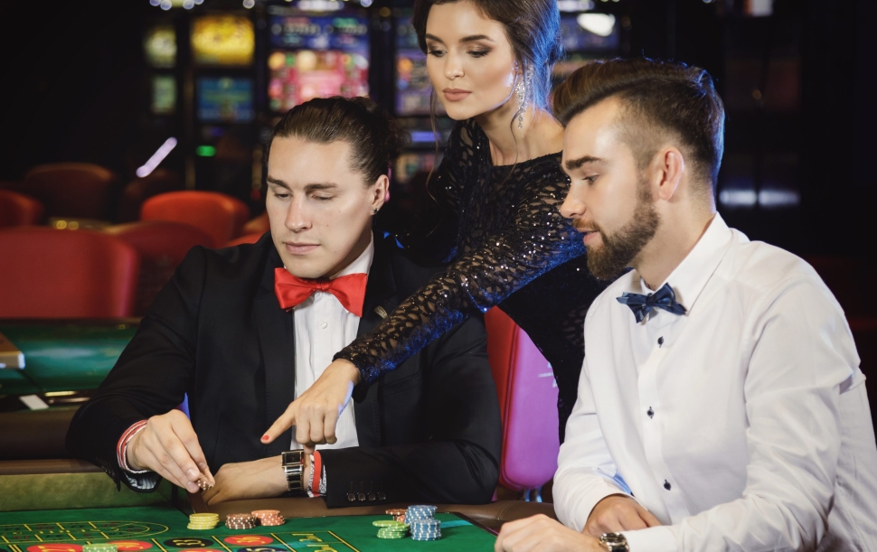 Group of young rich people playing roulette in the casino